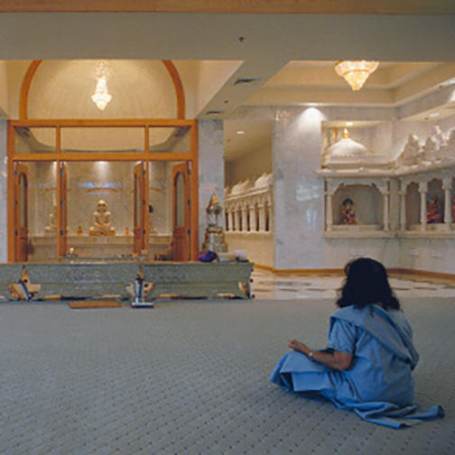 Woman Sitting in Prayer Hall